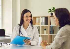 Medical doctor or physician consulting woman patient In office. Health care. Doctor writes prescription to patient